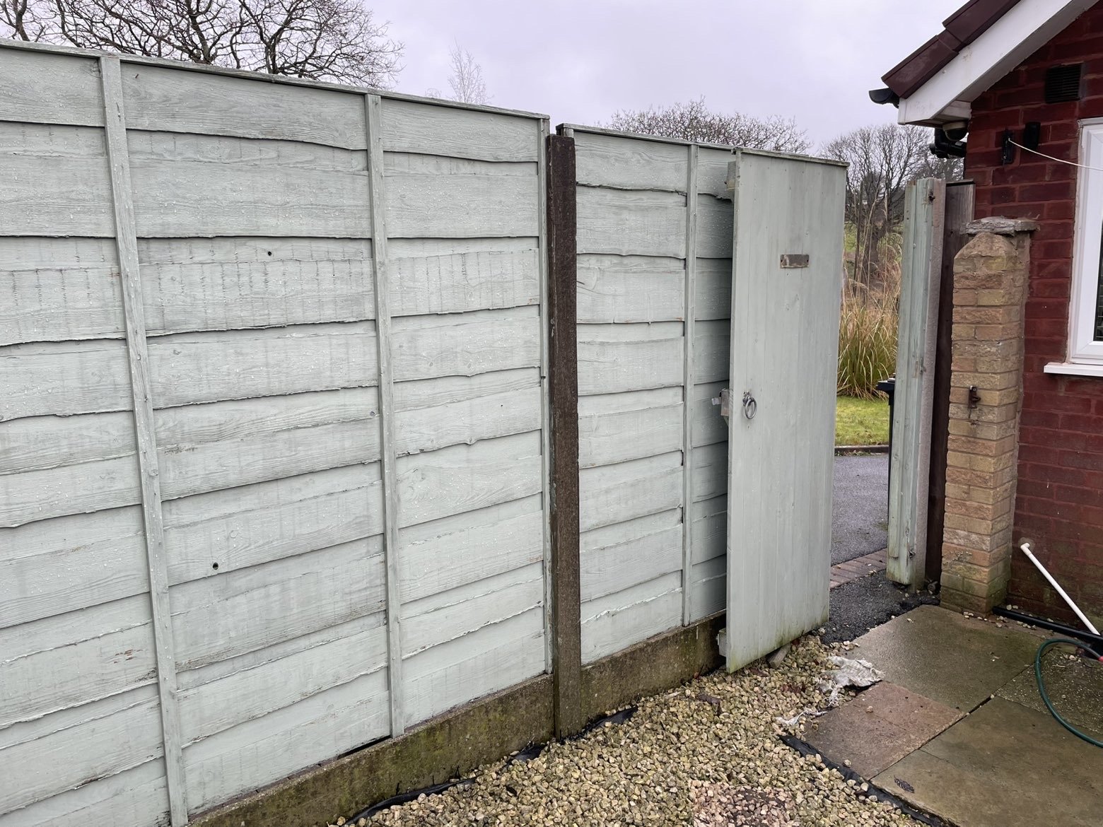 Weathered fence panels before replacement