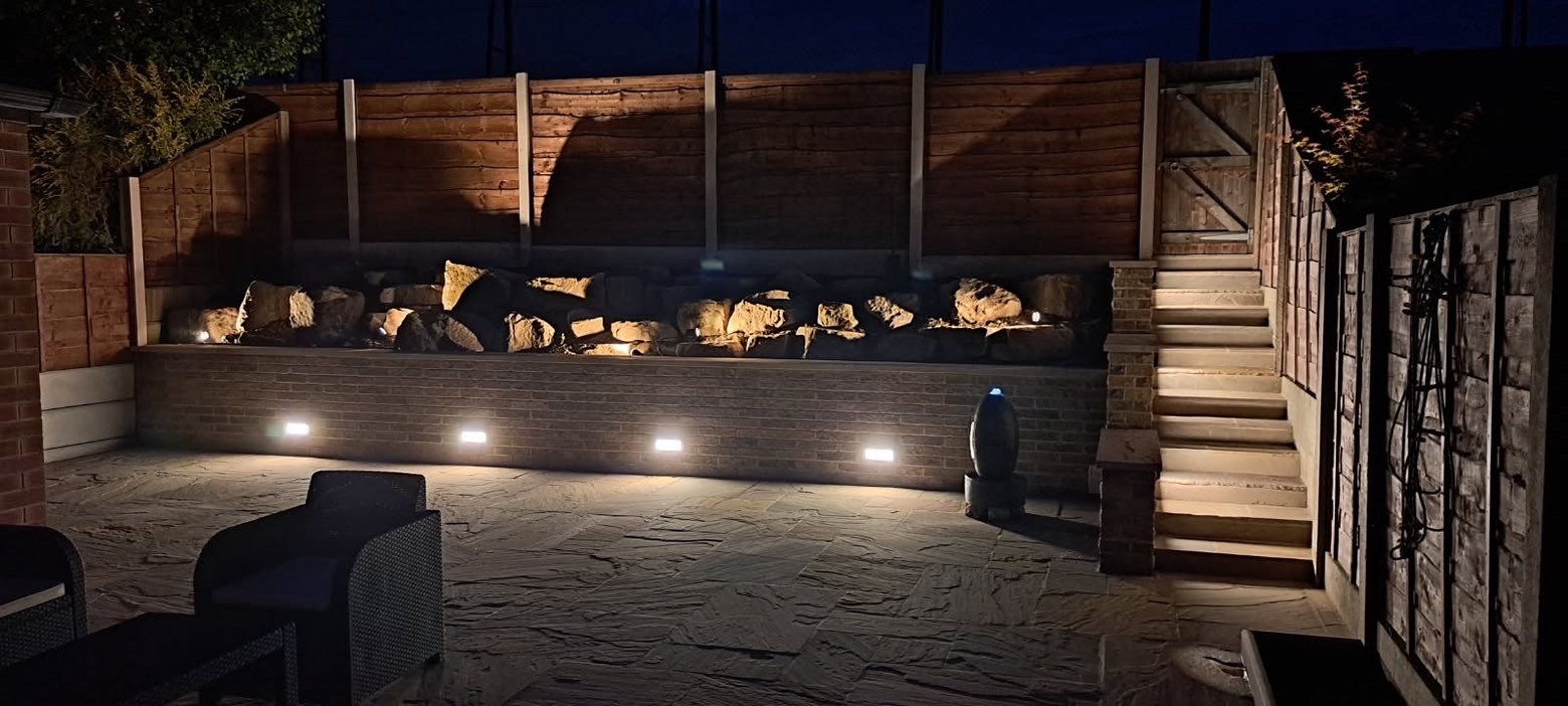 Raised stone bed with integrated lighting at night